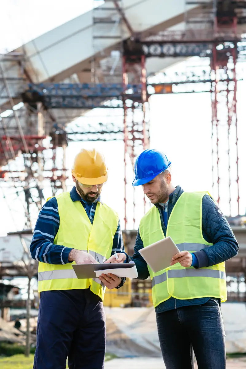 Construction engineers coordinating work on site